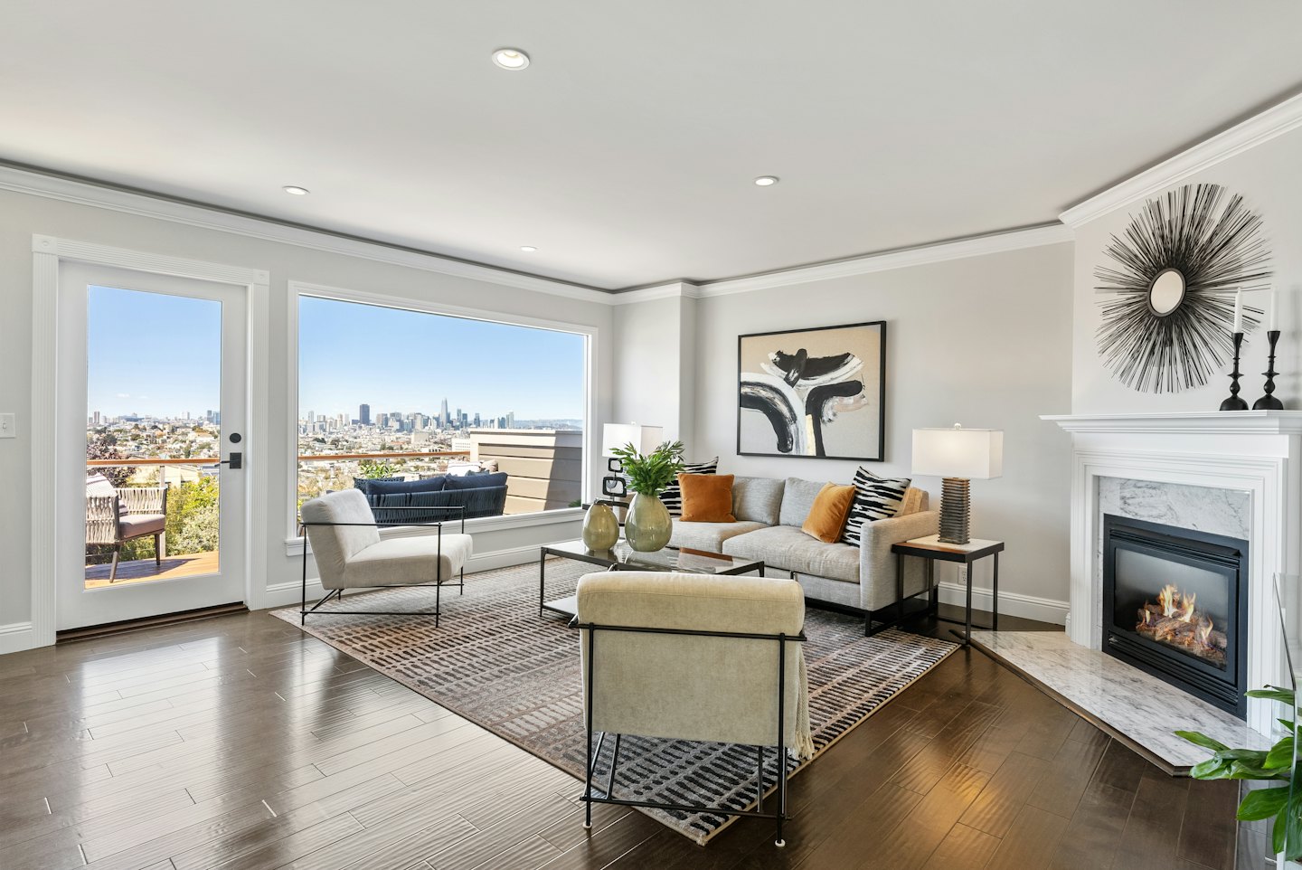 Modern living room with city skyline view through large window.