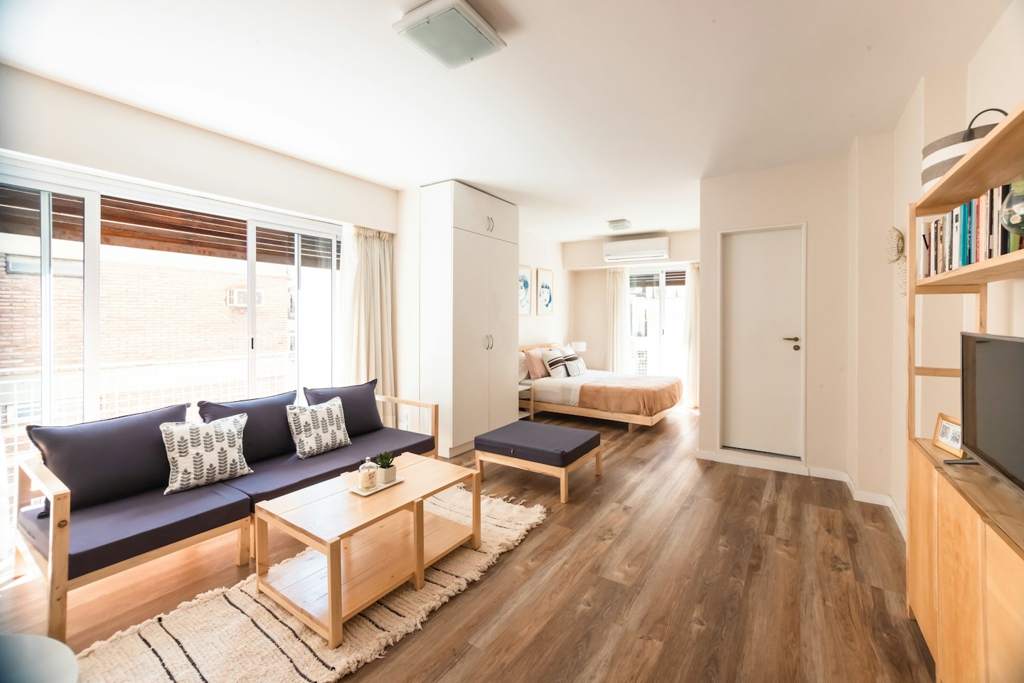 Modern studio apartment with living and bedroom areas.